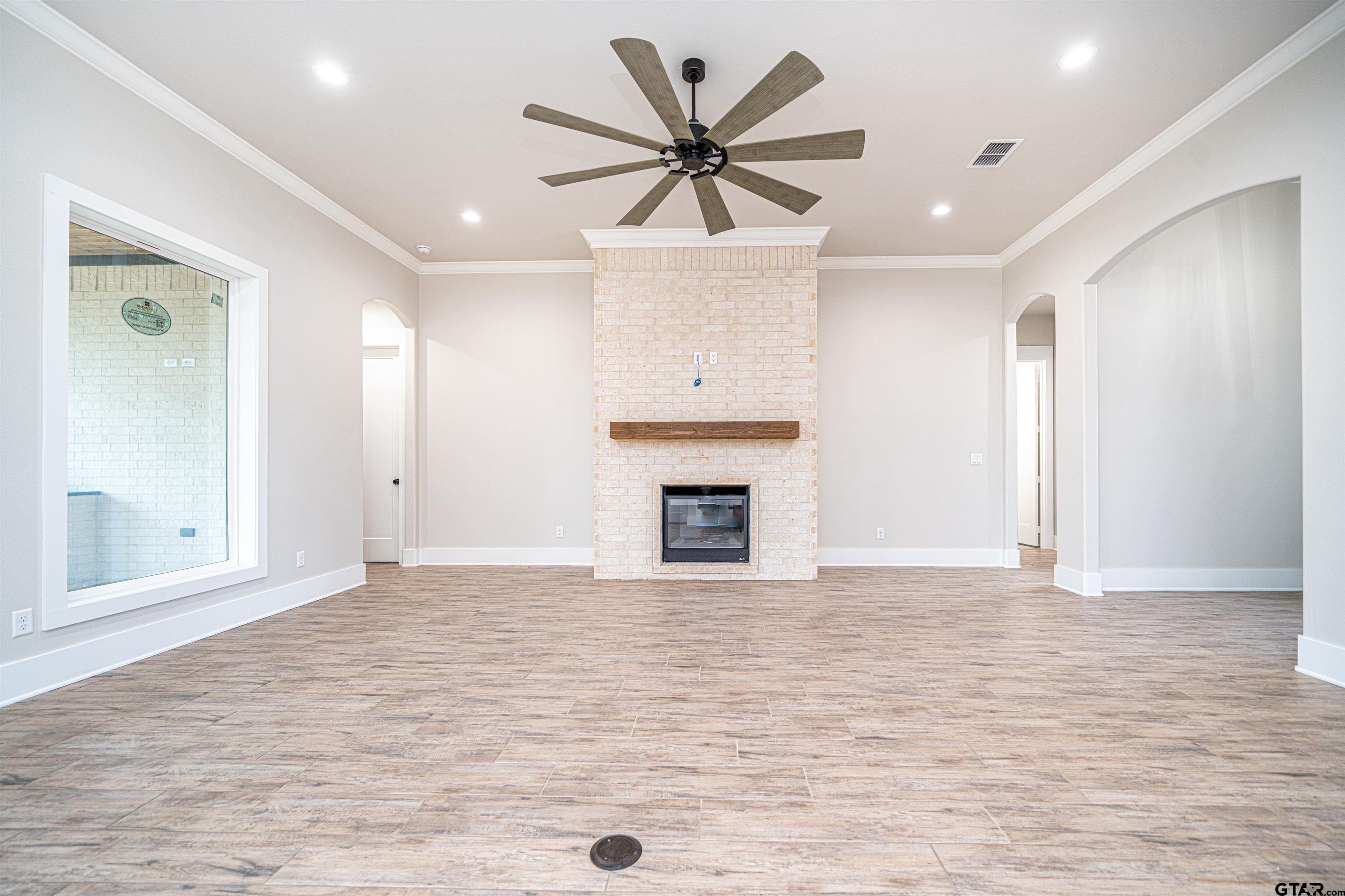 3910 Hidden Hills Circle Longview, TX 75605 - Photo 8 of 39 an empty room with fan and windows