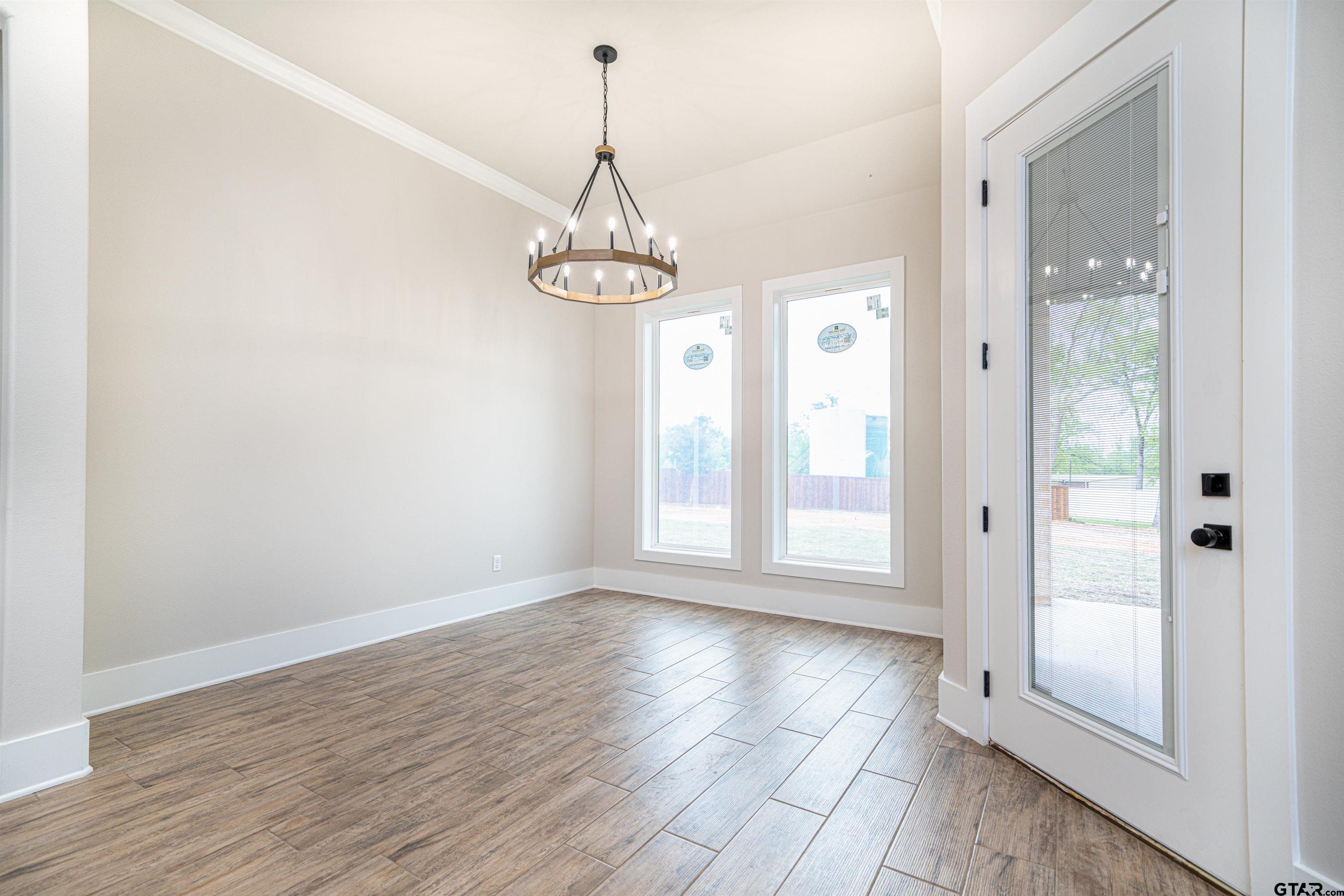 3910 Hidden Hills Circle Longview, TX 75605 - Photo 9 of 39 a view of empty room with wooden floor and window
