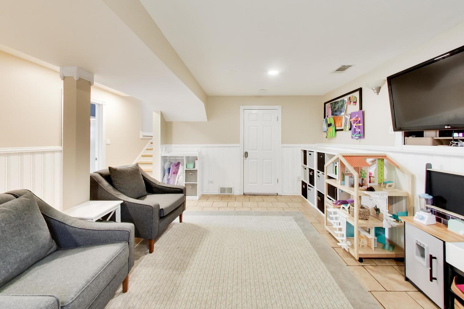 44 Swift Lane Naperville, IL 60565 - Photo 13 of 37 a living room with furniture and a flat screen tv