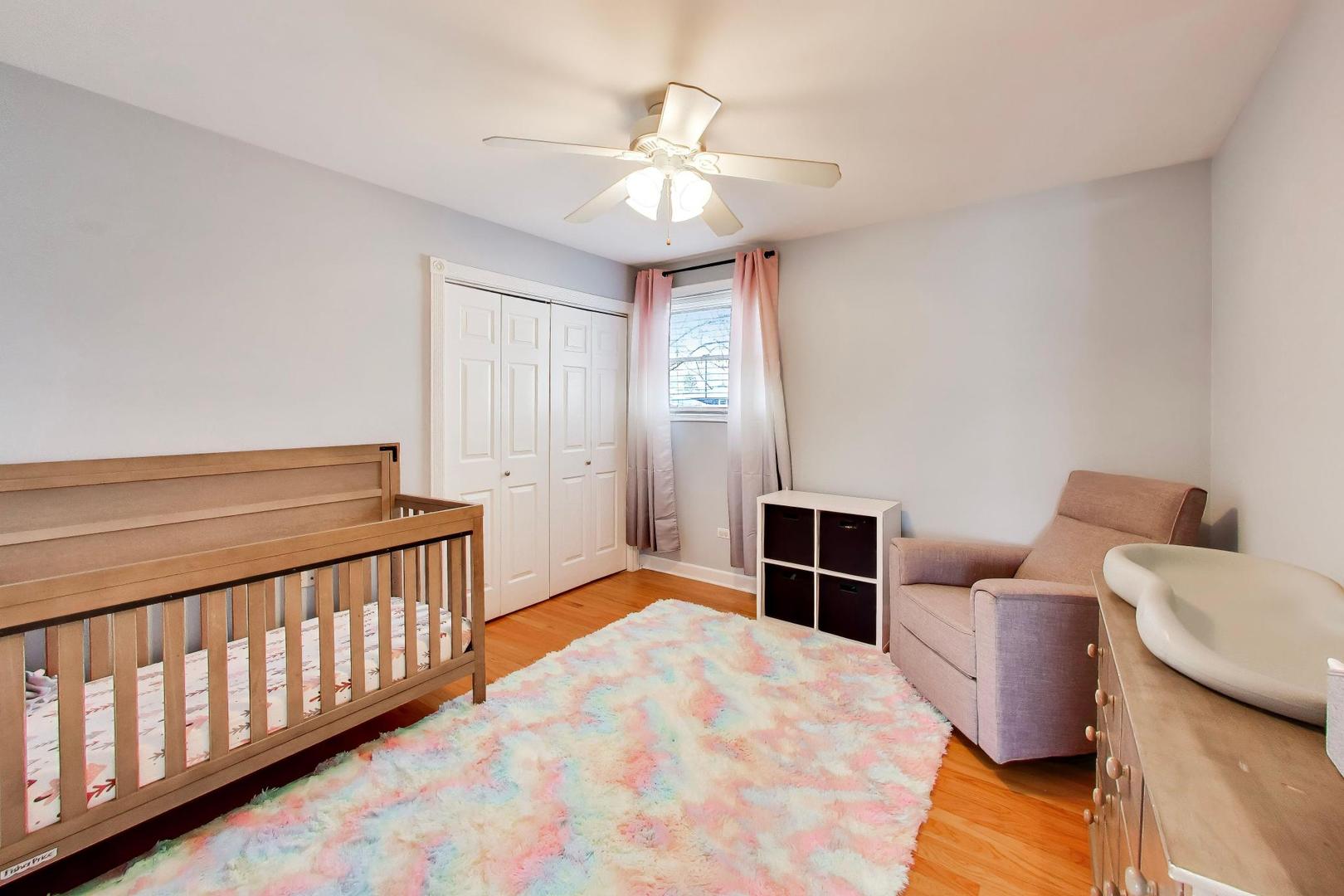44 Swift Lane Naperville, IL 60565 - Photo 16 of 37 a bedroom with furniture and wooden floor