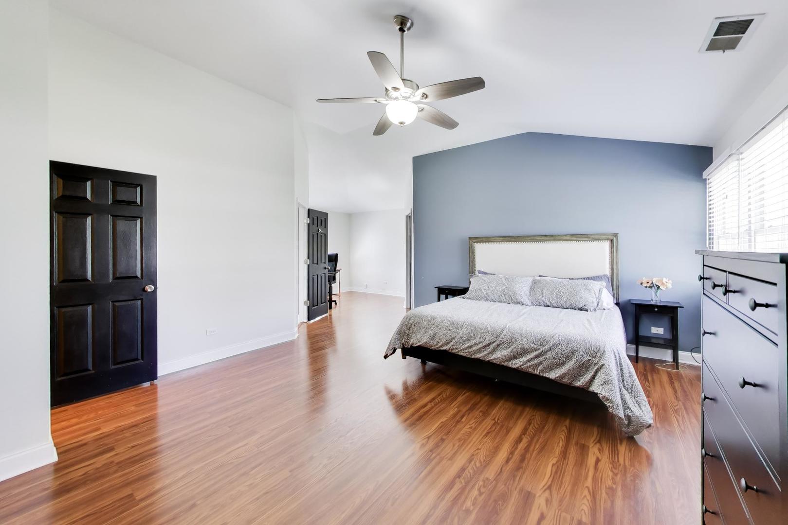 44 Swift Lane Naperville, IL 60565 - Photo 22 of 37 a bedroom with a bed and wooden floor