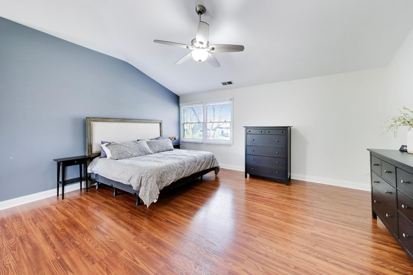 44 Swift Lane Naperville, IL 60565 - Photo 23 of 37 a bedroom with a bed and wooden floor