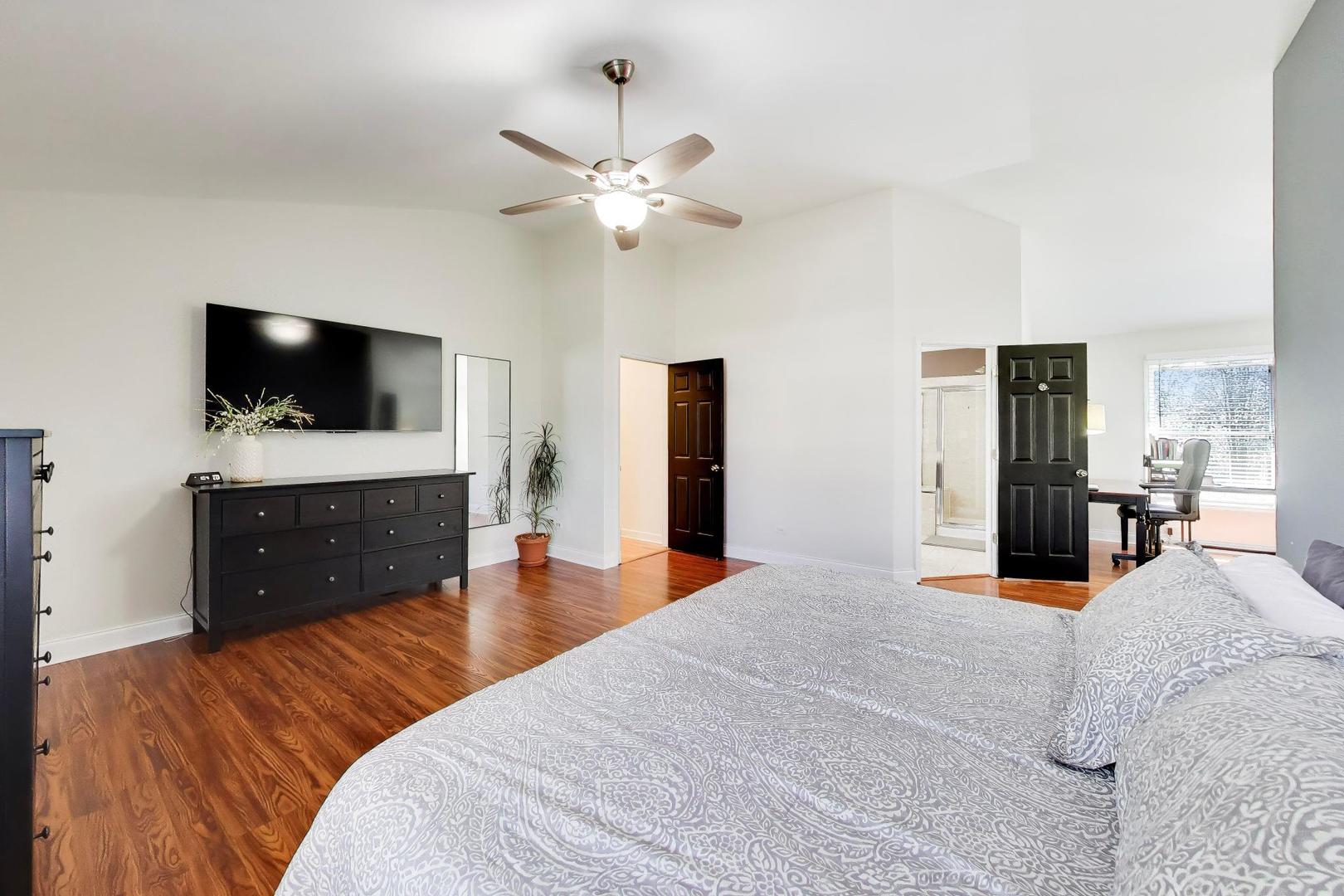 44 Swift Lane Naperville, IL 60565 - Photo 24 of 37 a bedroom with a bed and a flat screen tv