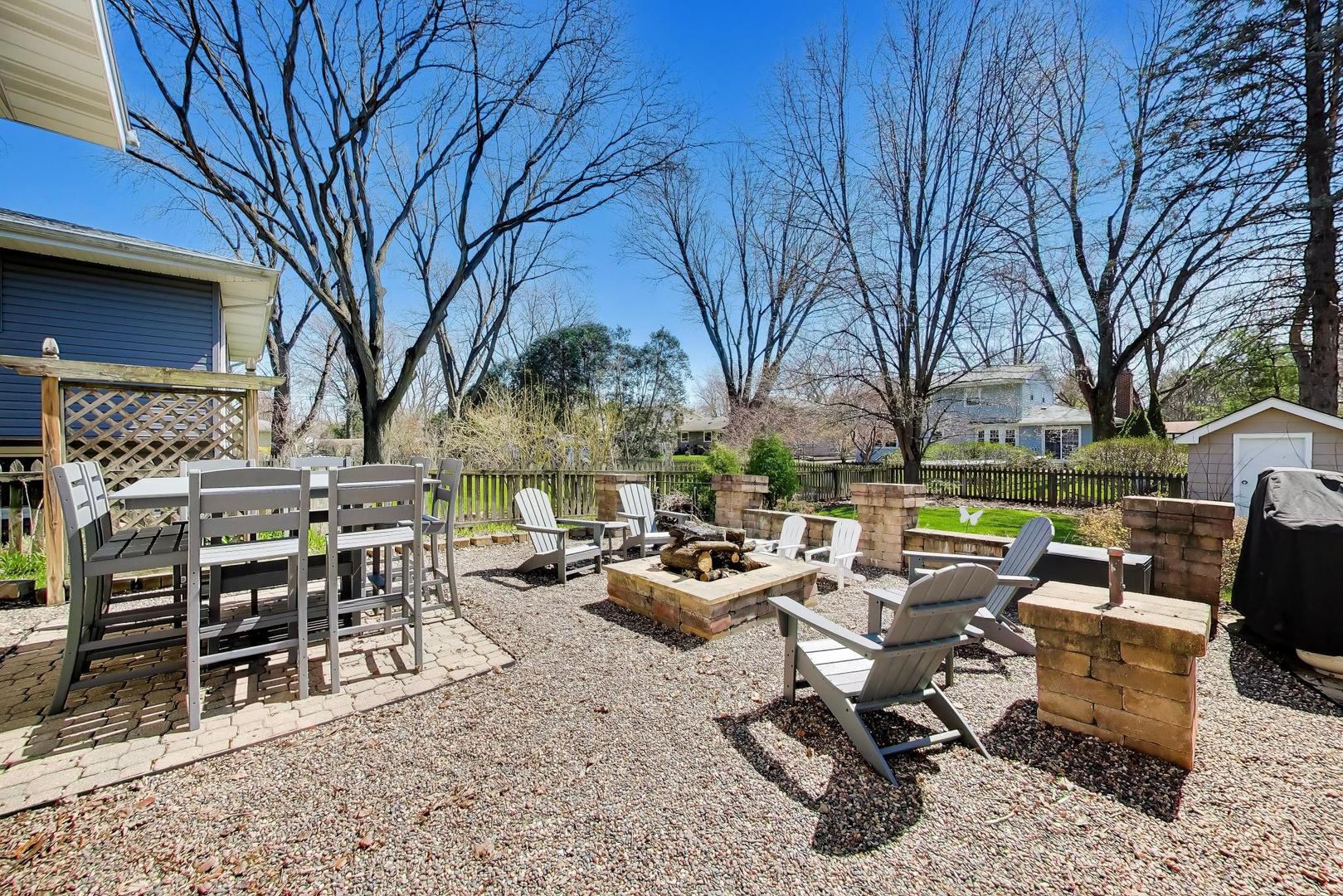 44 Swift Lane Naperville, IL 60565 - Photo 34 of 37 a backyard of a house with barbeque oven table and chairs