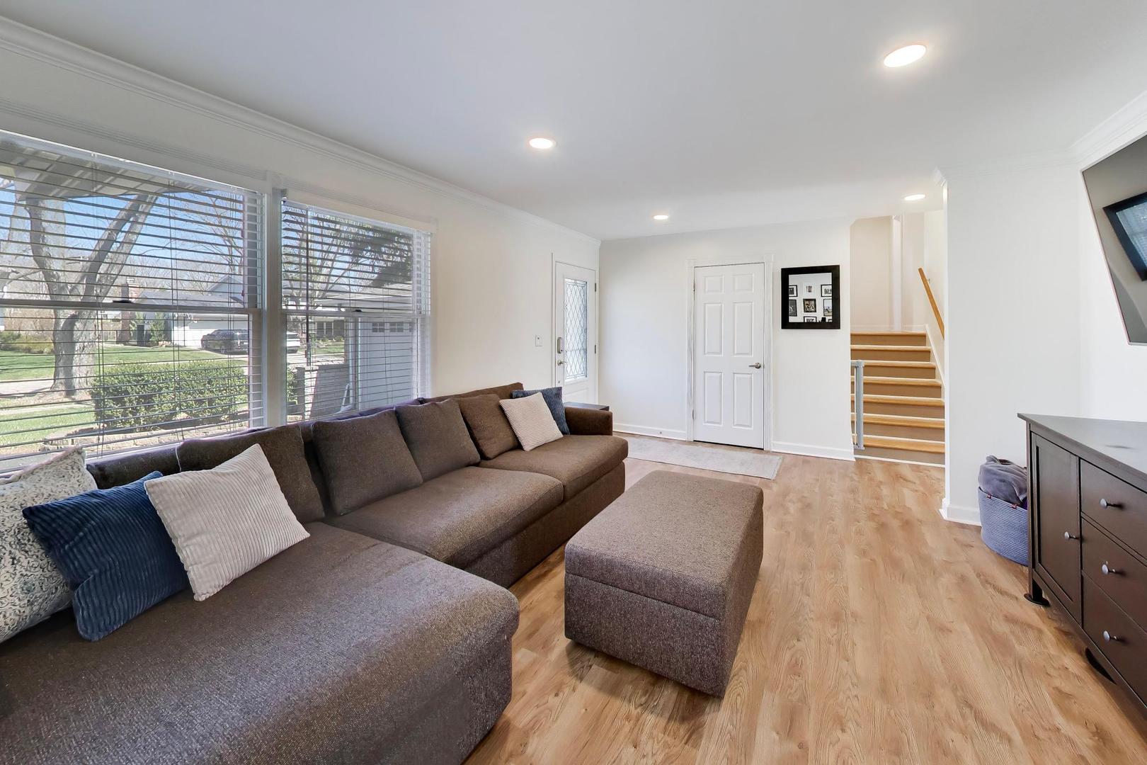 44 Swift Lane Naperville, IL 60565 - Photo 4 of 37 a living room with furniture and a flat screen tv