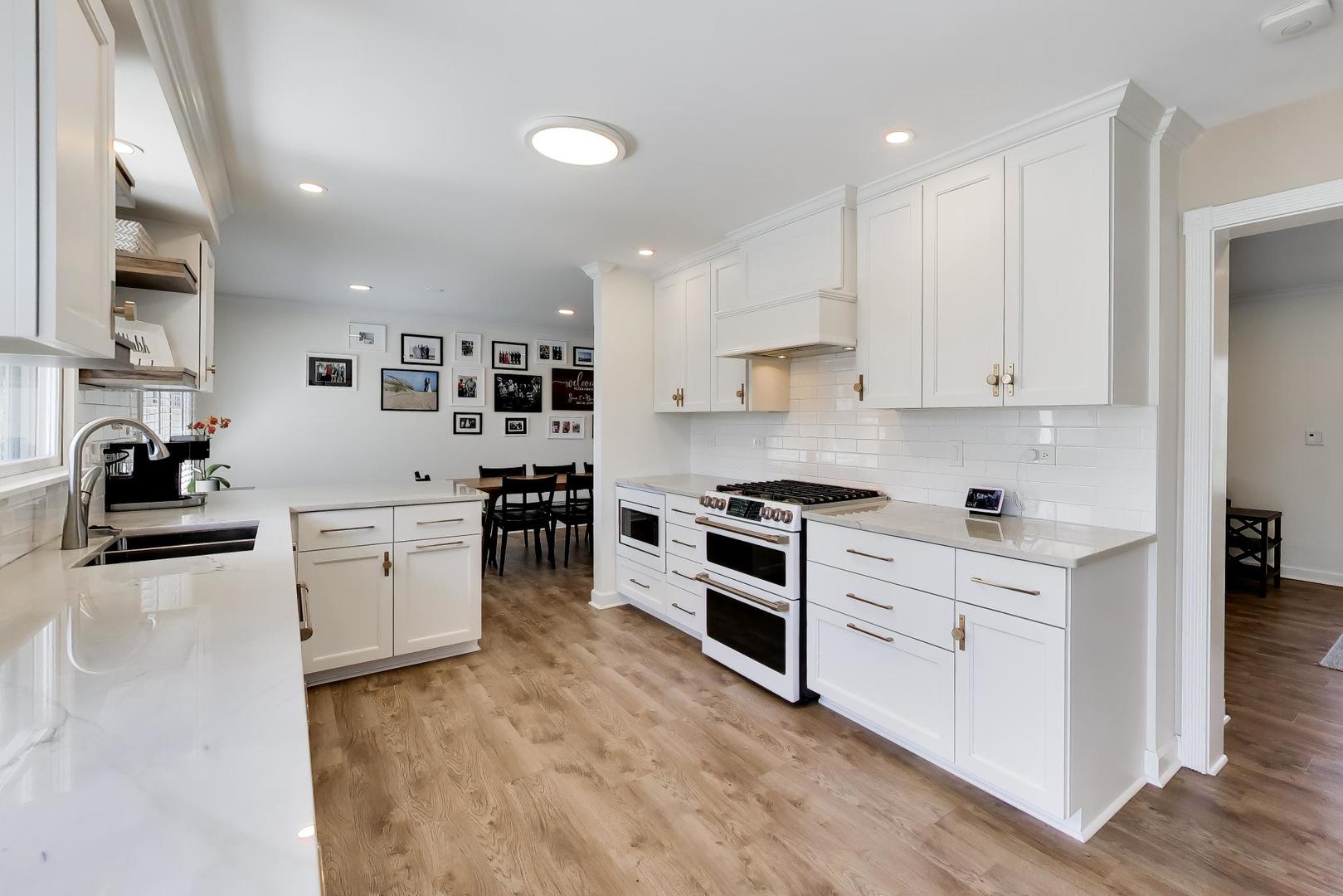44 Swift Lane Naperville, IL 60565 - Photo 8 of 37 a kitchen with granite countertop white cabinets and stainless steel appliances