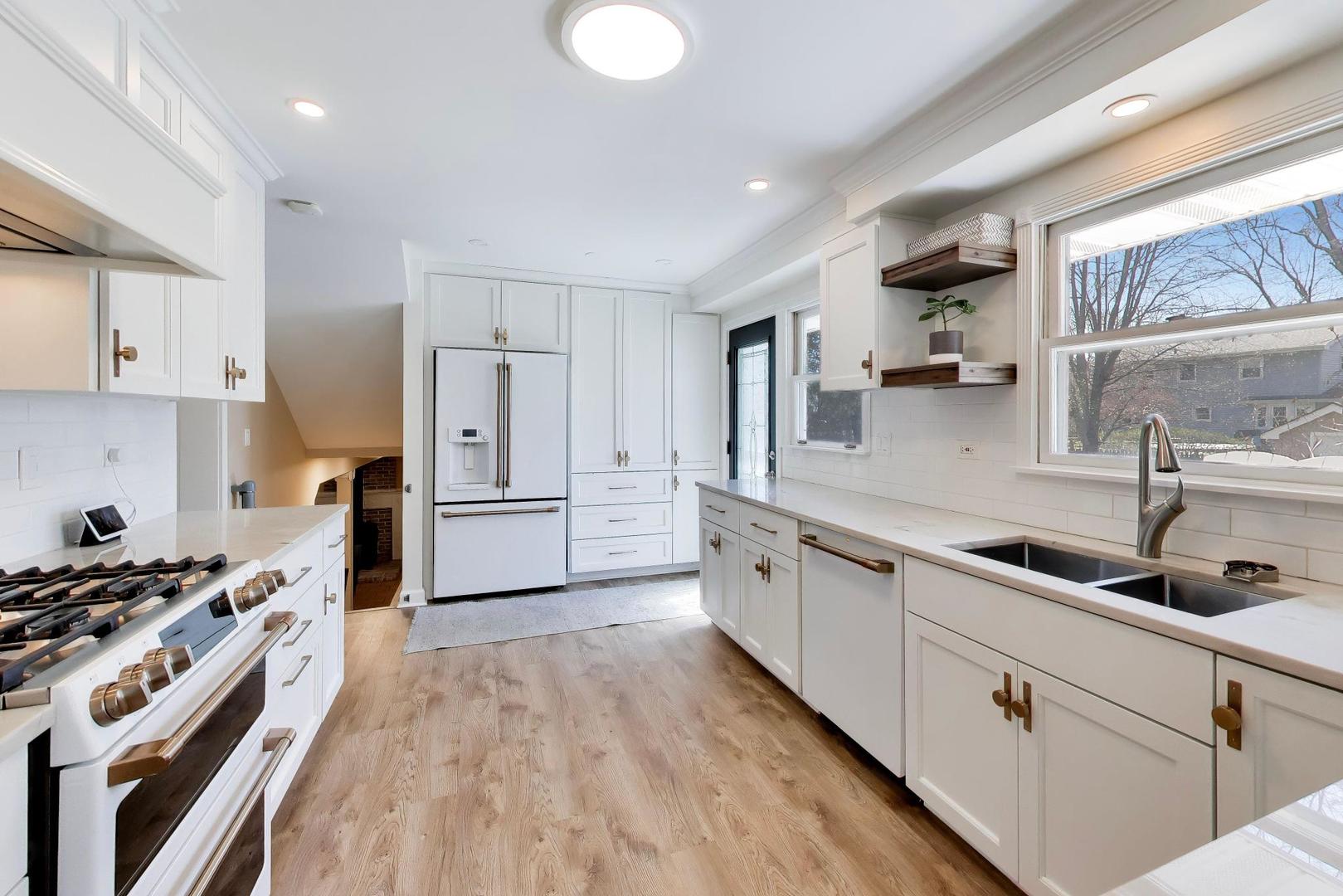 44 Swift Lane Naperville, IL 60565 - Photo 10 of 37 a kitchen with kitchen island a counter top space a sink stainless steel appliances and cabinets
