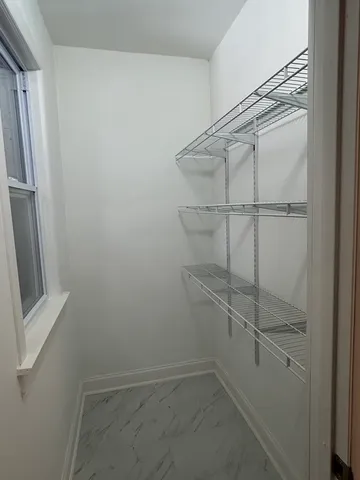 a view of a room with shelf on the wall