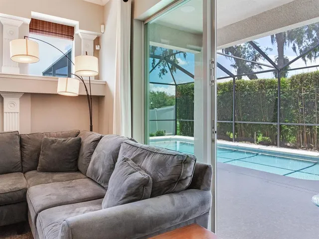 a kitchen with stainless steel appliances kitchen island granite countertop a refrigerator a stove and white cabinets with wooden floor