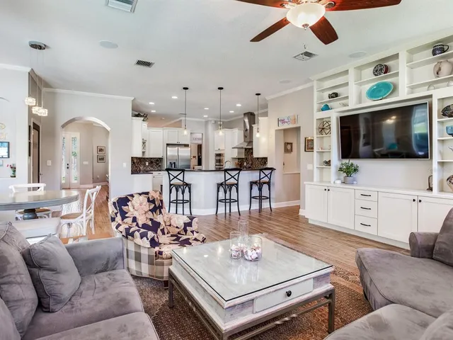 a spacious bedroom with a bed and a chandelier