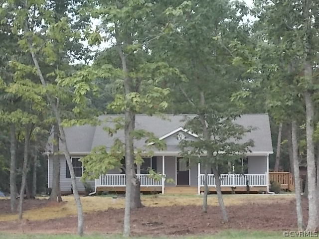 102 Jacoby Road Louisa, VA 23093 - Photo 1 of 24 a view of a patio with table and chairs and wooden fence