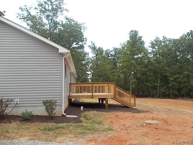 102 Jacoby Road Louisa, VA 23093 - Photo 21 of 24 a backyard of house with a barbeque and wooden stairs