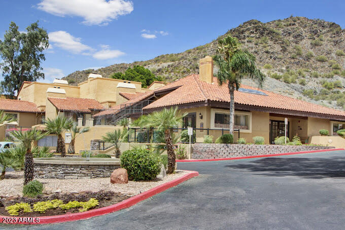 10002 North 7th Street, Unit B1 Phoenix, AZ 85020 - Photo 1 of 11 a front view of a house with a yard and potted plants