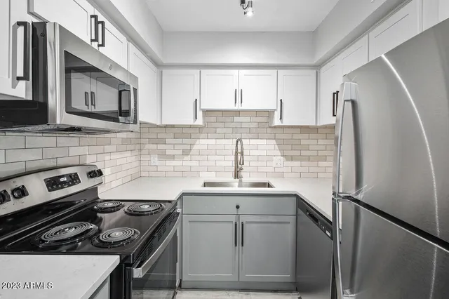 a kitchen with a sink stove and refrigerator