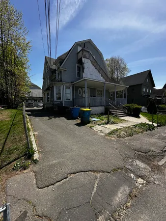 a wooden bench sitting in front of a house