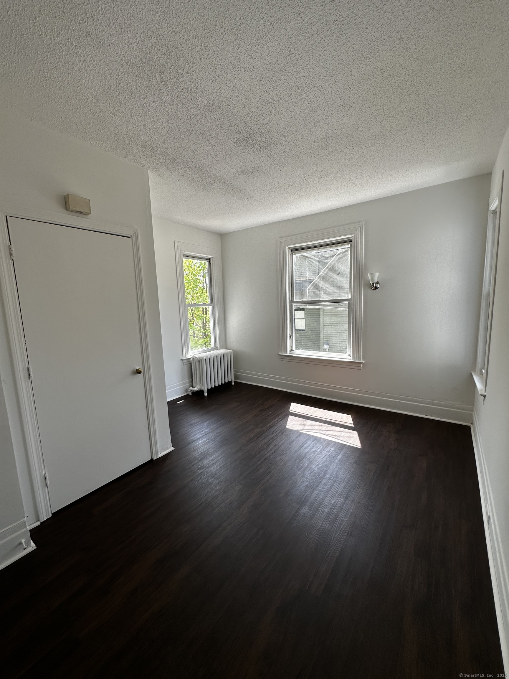 50 Chestnut Avenue Waterbury, CT 06710 - Photo 28 of 30 an empty room with wooden floor and windows