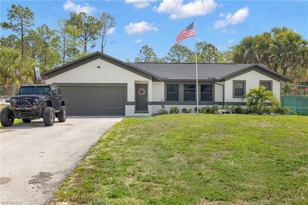 910 13th Street Southwest Naples, FL 34117 - Photo 1 of 1 a front view of a house with a garden