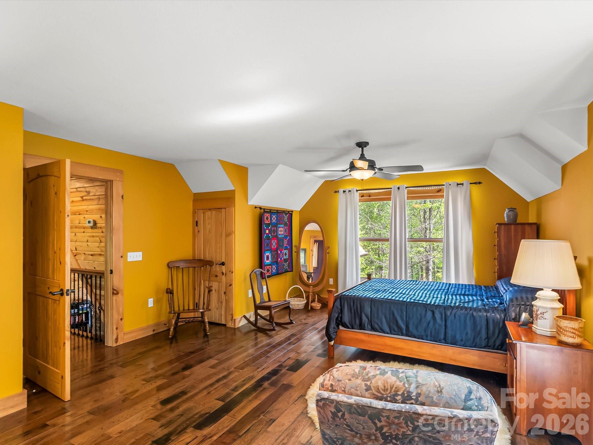 917 Otter Mountain Road Topton, NC 28781 - Photo 35 of 48 a bedroom with a bed and wooden floor