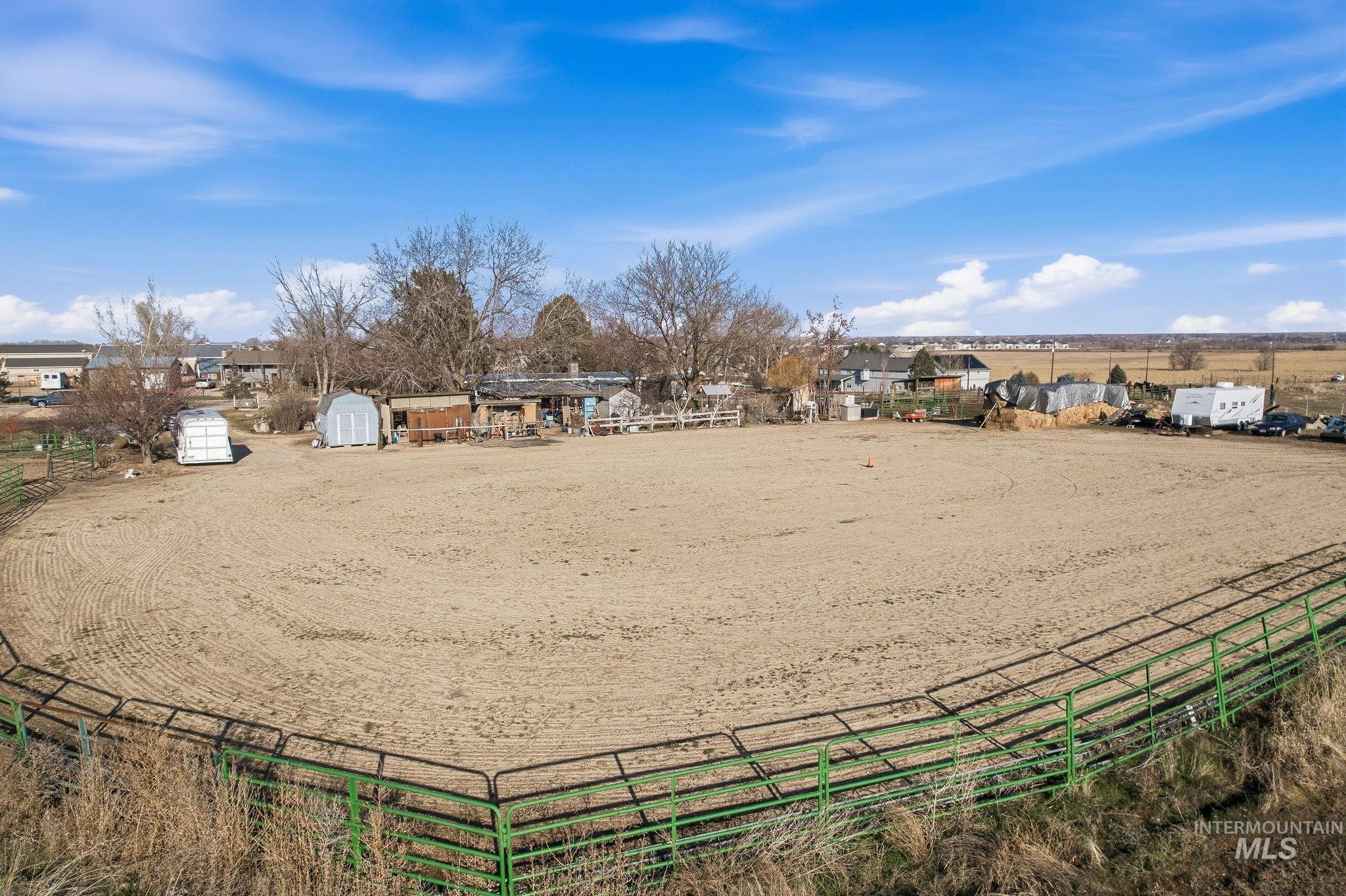 603 East King Road Kuna, ID 83634 - Photo 9 of 24 View of property's community with an enclosed horse arena, a rural view, and an outdoor structure