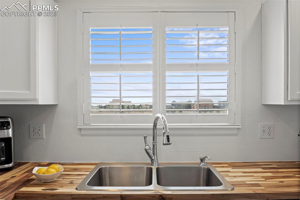 11916 Bonifay Loop Peyton, CO 80831 - Photo 11 of 42 a kitchen with a sink and a window