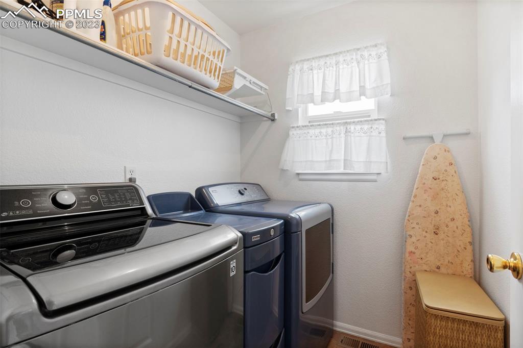 11916 Bonifay Loop Peyton, CO 80831 - Photo 18 of 42 a utility room with dryer and washer