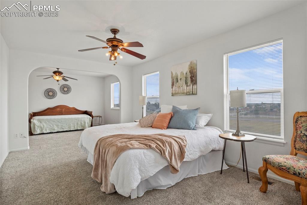 11916 Bonifay Loop Peyton, CO 80831 - Photo 19 of 42 a bedroom with two beds and painting on the wall