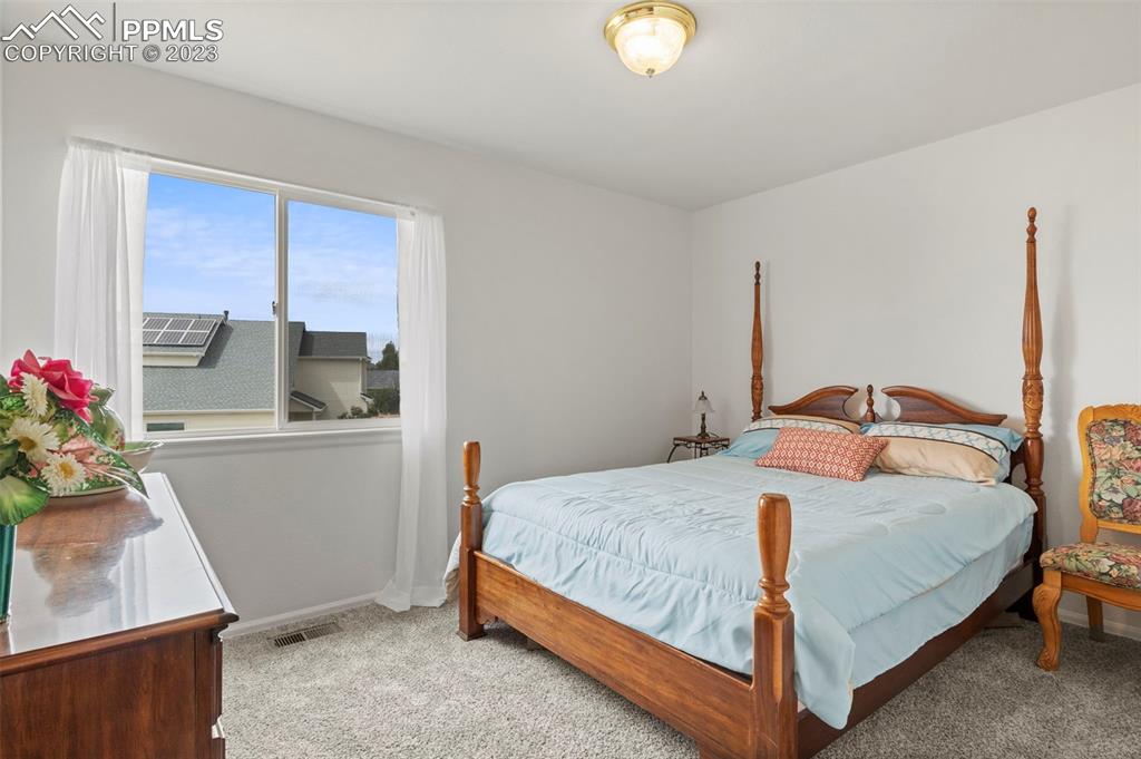 11916 Bonifay Loop Peyton, CO 80831 - Photo 23 of 42 a bedroom with a bed and window