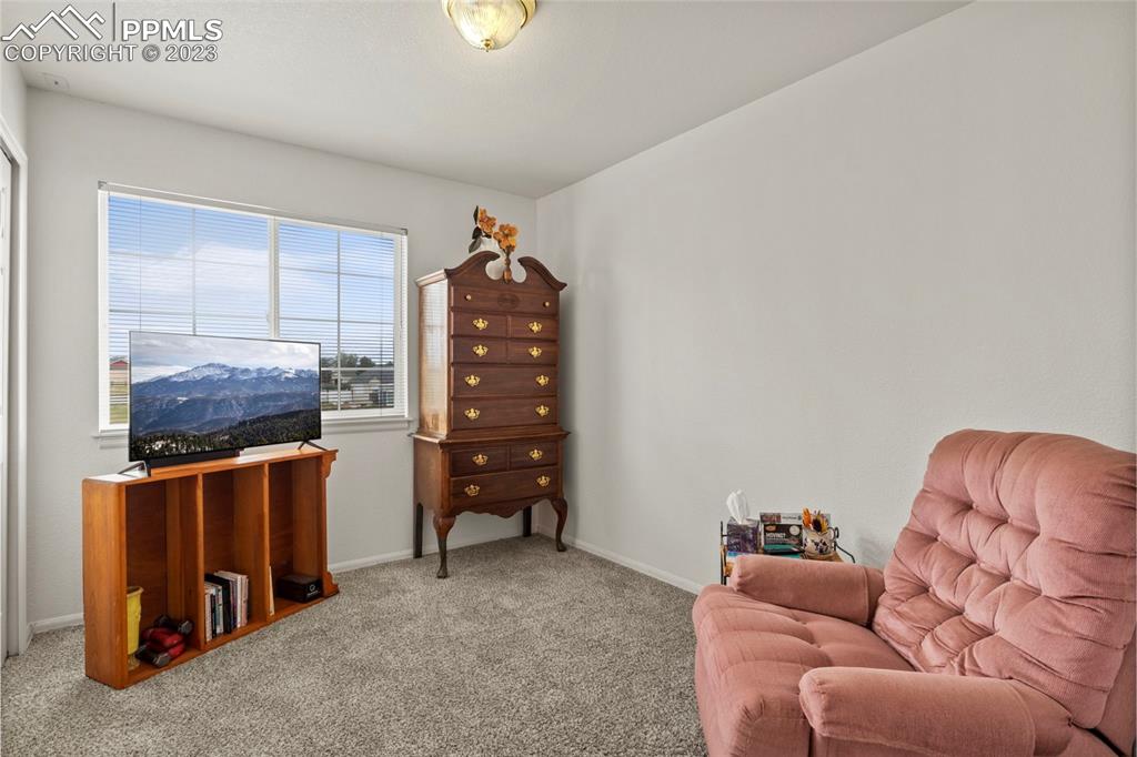 11916 Bonifay Loop Peyton, CO 80831 - Photo 25 of 42 a living room with furniture and a air conditioner vent