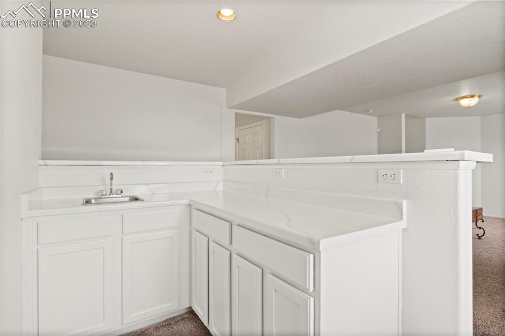 11916 Bonifay Loop Peyton, CO 80831 - Photo 28 of 42 a bathroom with a sink and a mirror