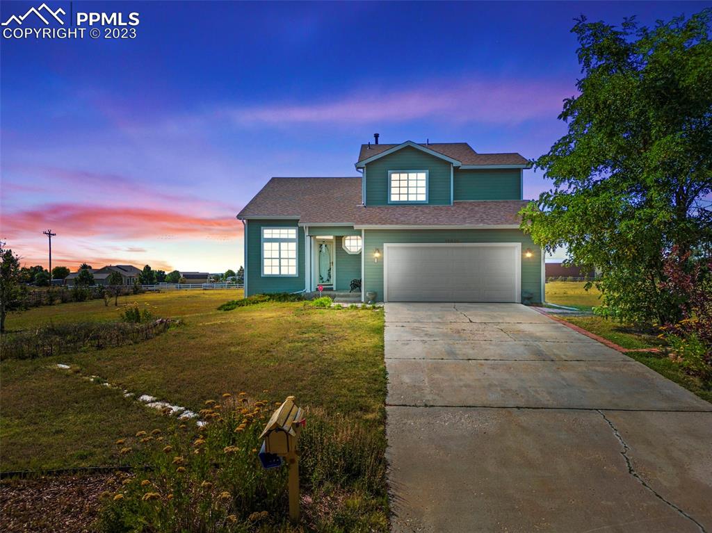 11916 Bonifay Loop Peyton, CO 80831 - Photo 3 of 42 a view of a house with a yard