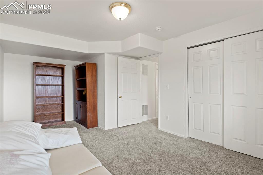 11916 Bonifay Loop Peyton, CO 80831 - Photo 31 of 42 a view of a bedroom with closet and natural light