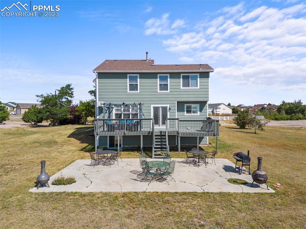 11916 Bonifay Loop Peyton, CO 80831 - Photo 37 of 42 a view of a house with swimming pool and sitting area