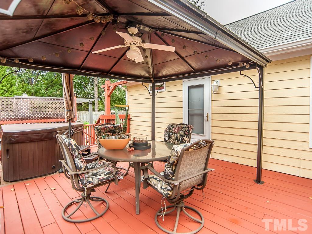4217 Mardela Spring Drive Raleigh, NC 27616 - Photo 2 of 26 a view of a patio with table and chairs under an umbrella