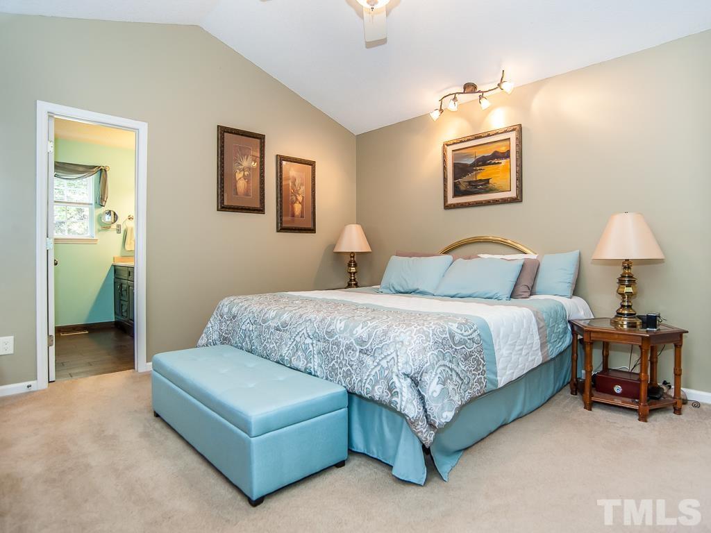 4217 Mardela Spring Drive Raleigh, NC 27616 - Photo 13 of 26 a bedroom with a bed and a lamp on table