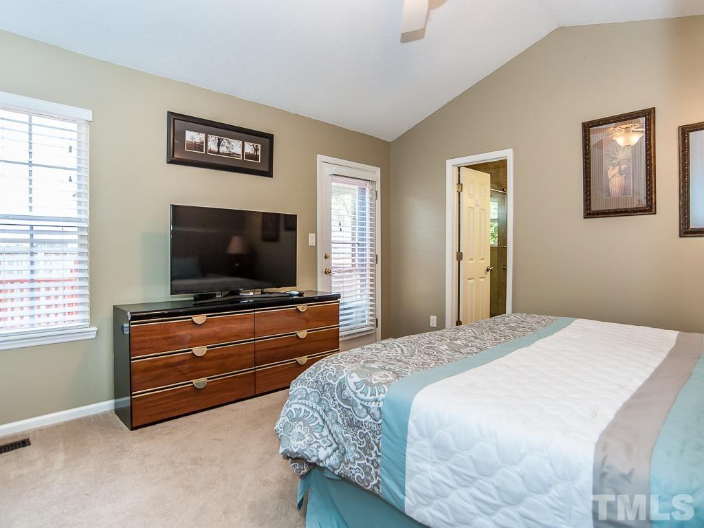 4217 Mardela Spring Drive Raleigh, NC 27616 - Photo 14 of 26 a bedroom with a bed and a flat screen tv