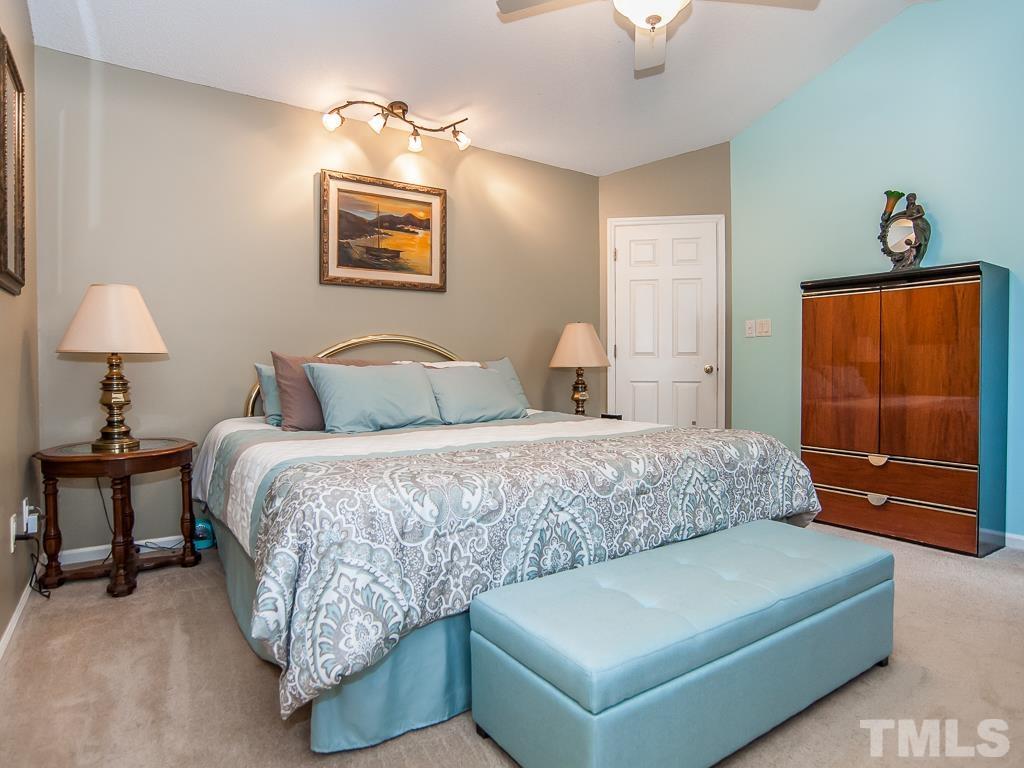 4217 Mardela Spring Drive Raleigh, NC 27616 - Photo 15 of 26 a bedroom with a bed and a lamp on dresser