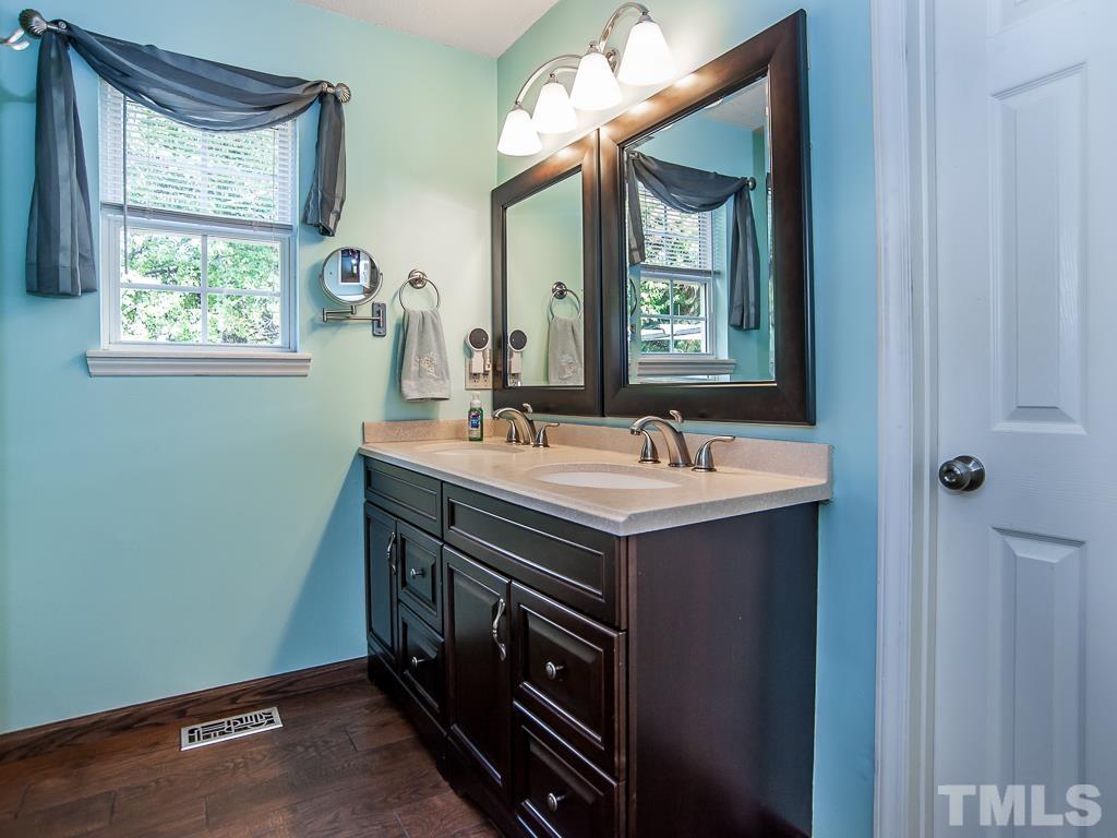 4217 Mardela Spring Drive Raleigh, NC 27616 - Photo 17 of 26 a bathroom with a sink and a mirror