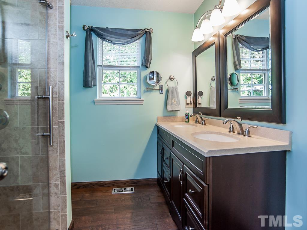 4217 Mardela Spring Drive Raleigh, NC 27616 - Photo 18 of 26 a bathroom with a double vanity sink and a mirror