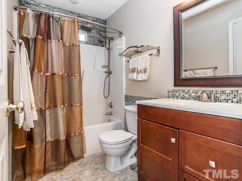 4217 Mardela Spring Drive Raleigh, NC 27616 - Photo 23 of 26 a bathroom with a granite countertop sink toilet and shower