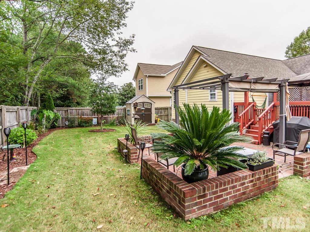 4217 Mardela Spring Drive Raleigh, NC 27616 - Photo 4 of 26 a view of a backyard with plants and a patio