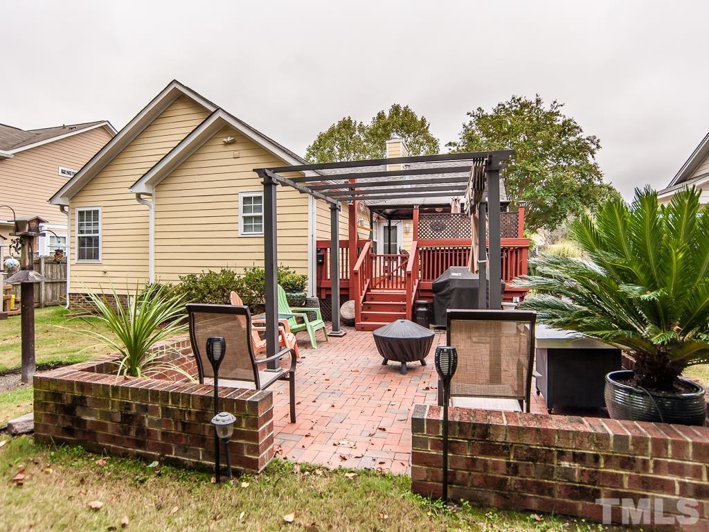 4217 Mardela Spring Drive Raleigh, NC 27616 - Photo 6 of 26 a view of house with backyard outdoor seating and trees in the background