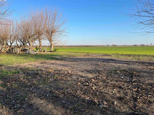 an aerial view of a house with a yard basket ball court and outdoor seating