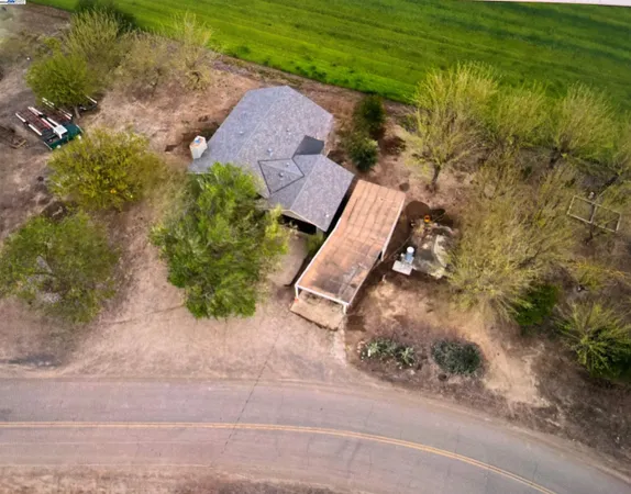 an aerial view of a house with a yard basket ball court and outdoor seating