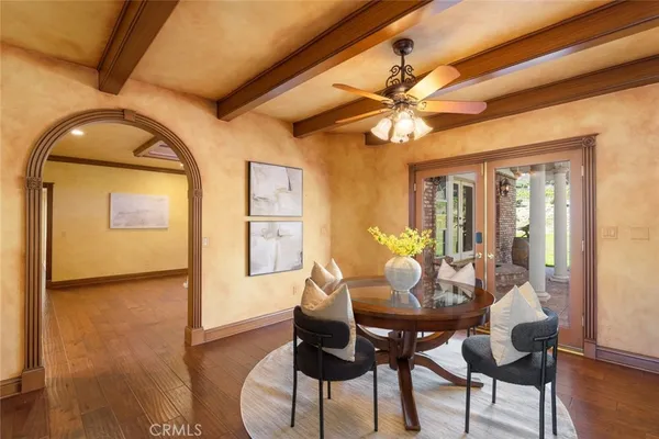 a view of a kitchen with stainless steel appliances granite countertop a stove and a dining table chair
