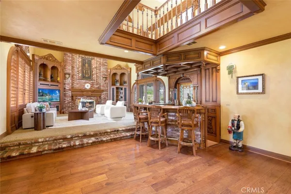 a bedroom with a bed a chandelier and a window