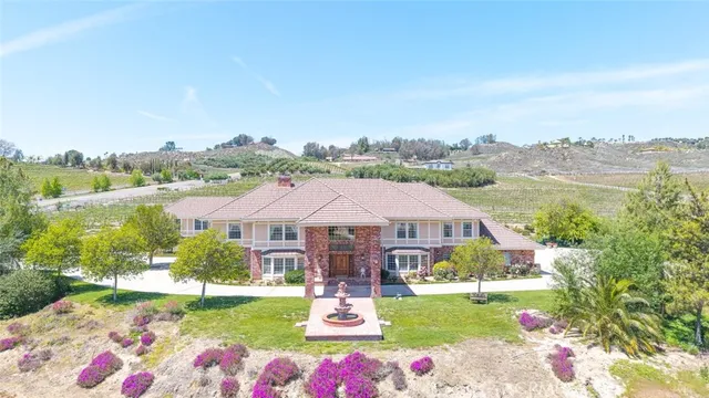 a front view of a house with swimming pool garden and outdoor seating