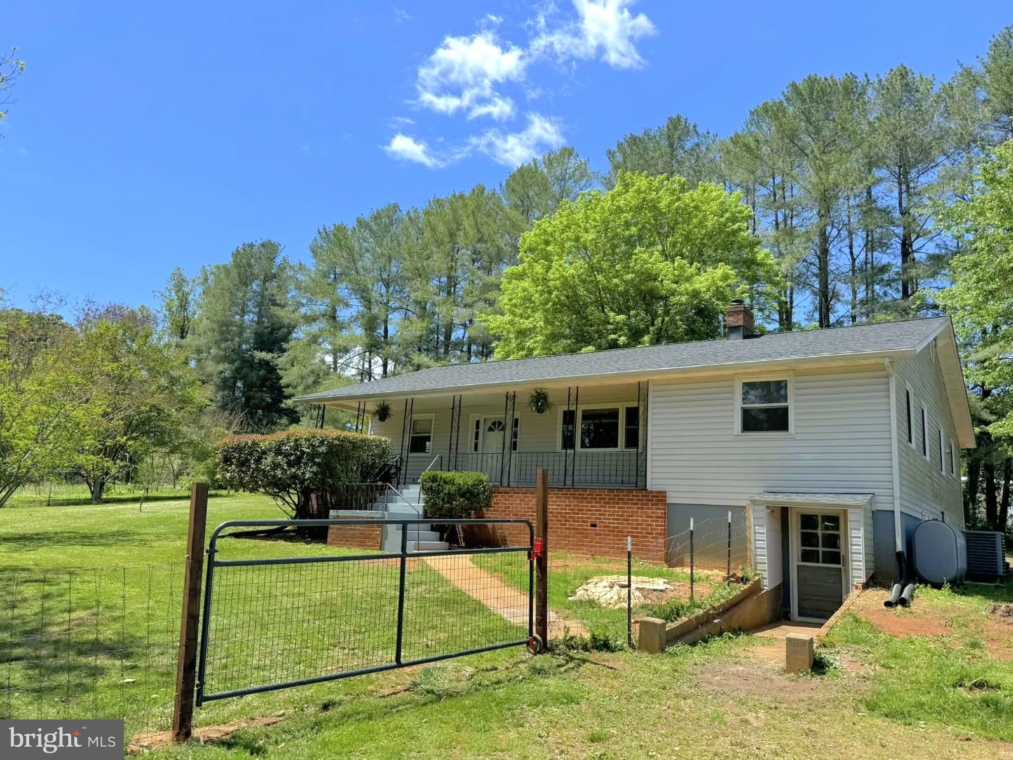 679 Resettlement Road Madison, VA 22727 - Photo 1 of 47 a view of a house with backyard and sitting area