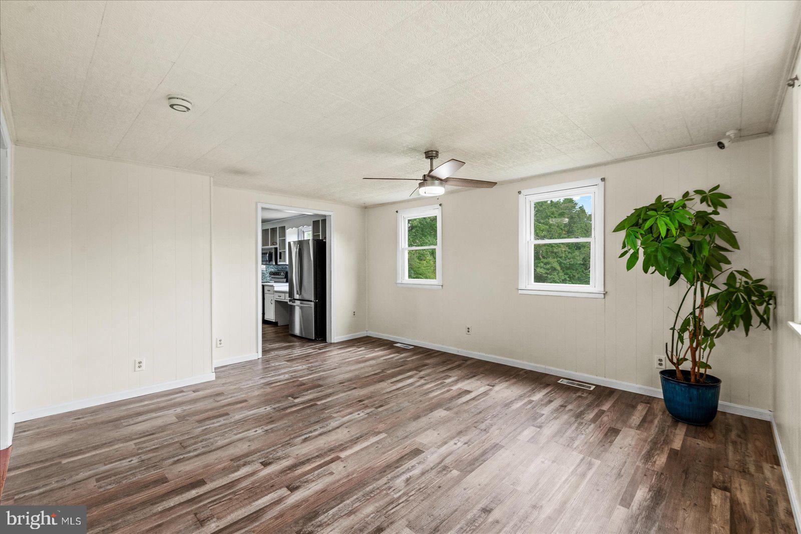 679 Resettlement Road Madison, VA 22727 - Photo 13 of 47 a view of an empty room with a window and wooden floor