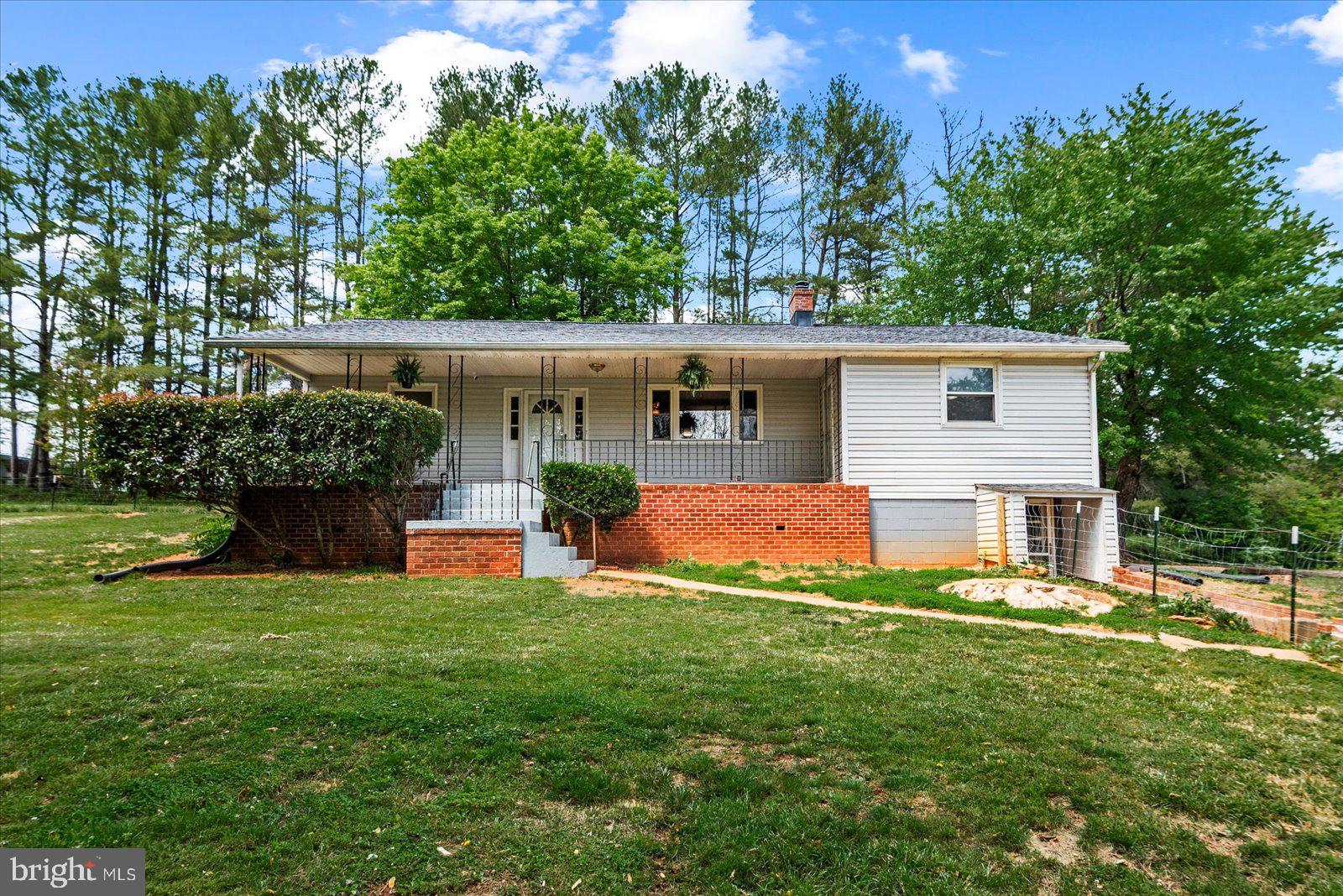 679 Resettlement Road Madison, VA 22727 - Photo 2 of 47 a front view of a house with yard and green space