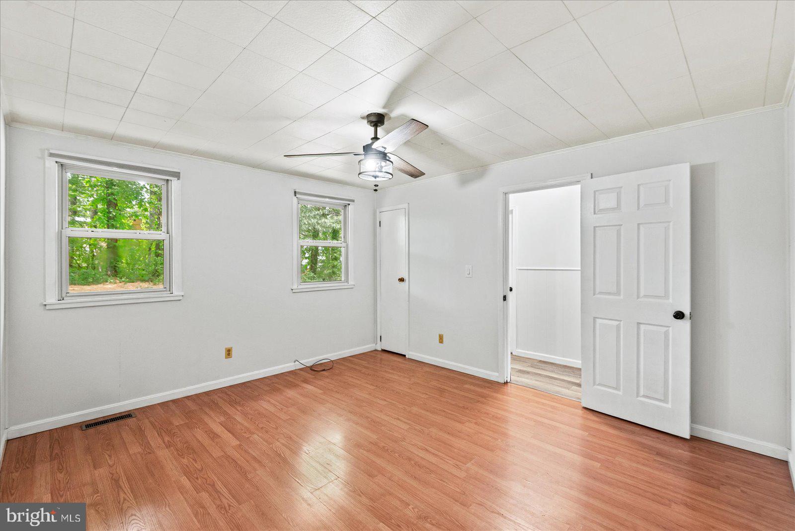 679 Resettlement Road Madison, VA 22727 - Photo 23 of 47 a view of an empty room with wooden floor and a window
